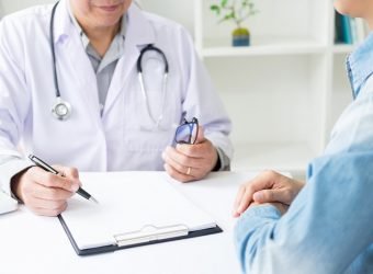 patient listening intently to a male doctor explaining patient s