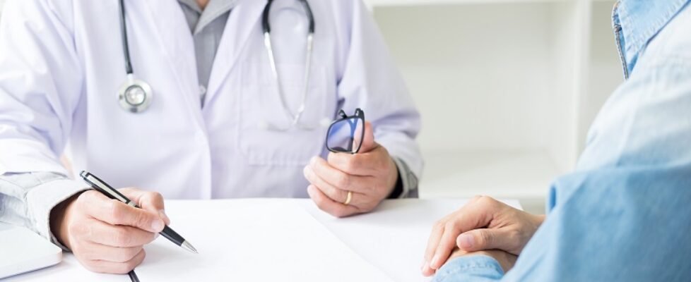 patient listening intently to a male doctor explaining patient s