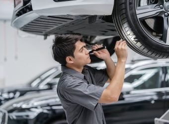 Asian mechanic Checking and torch tire in maintainance service c