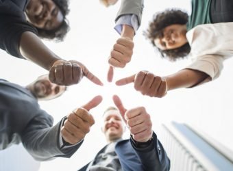 Business people giving a thumbs up