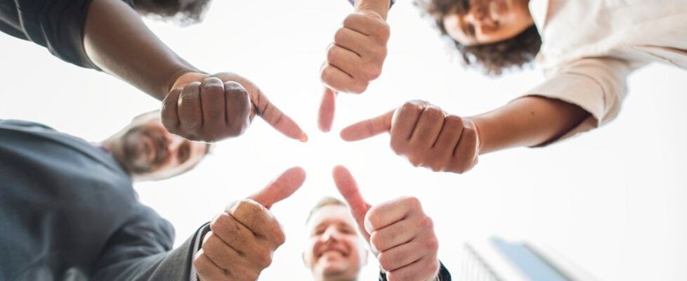 Business people giving a thumbs up
