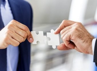 Business and Teamwork concept; business hands putting puzzle pie