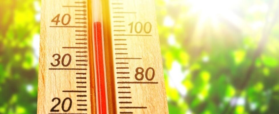 Thermometer displaying high 40 degree hot temperatures in sun summer day.
