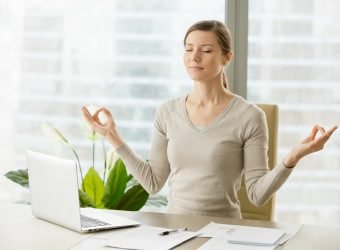 Calm businesswoman relaxing with breath gymnastics