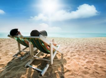 Couple sunbathing on a beach chair and umbrella color The beach