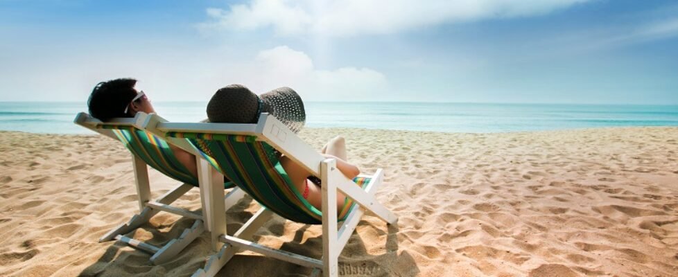 Couple sunbathing on a beach chair and umbrella color The beach