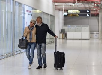 Senior couple traveling airport scene
