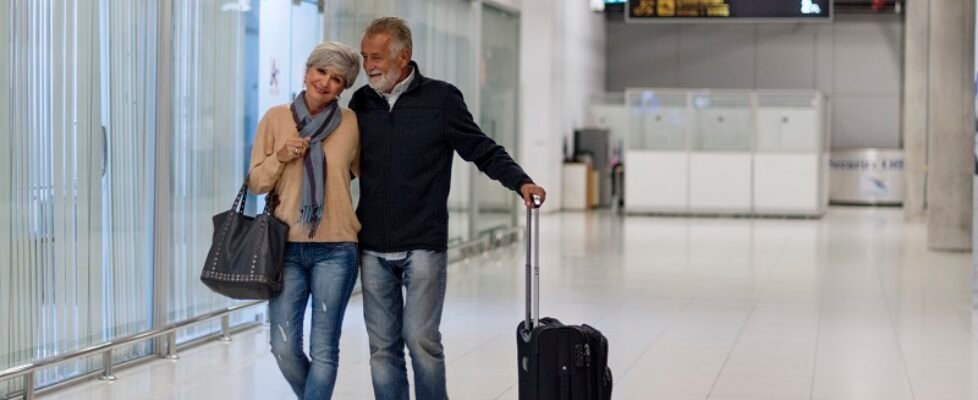 Senior couple traveling airport scene