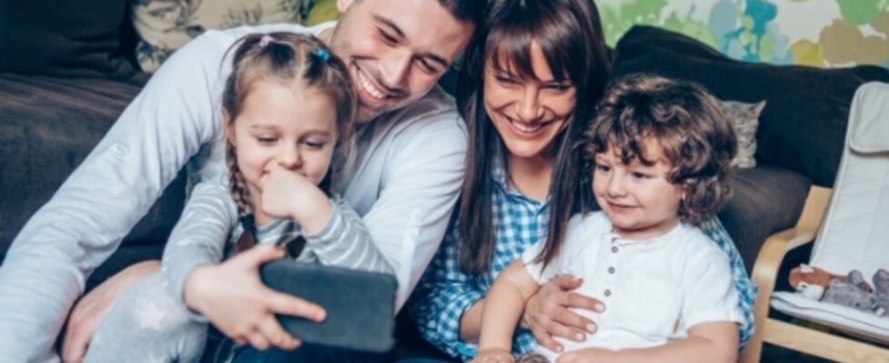 Happy family looking at smart phone