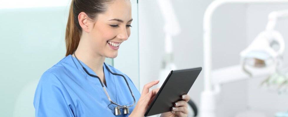 Dentist consulting online information in a tablet