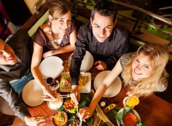 Young people eating in Thai restaurant