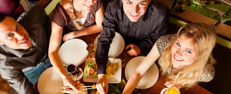 Young people eating in Thai restaurant