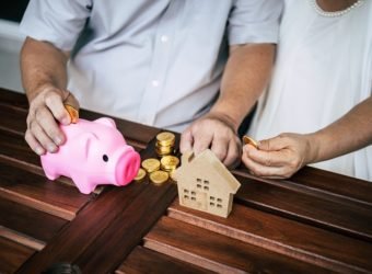 Elderly Couples talking about finance with piggy bank