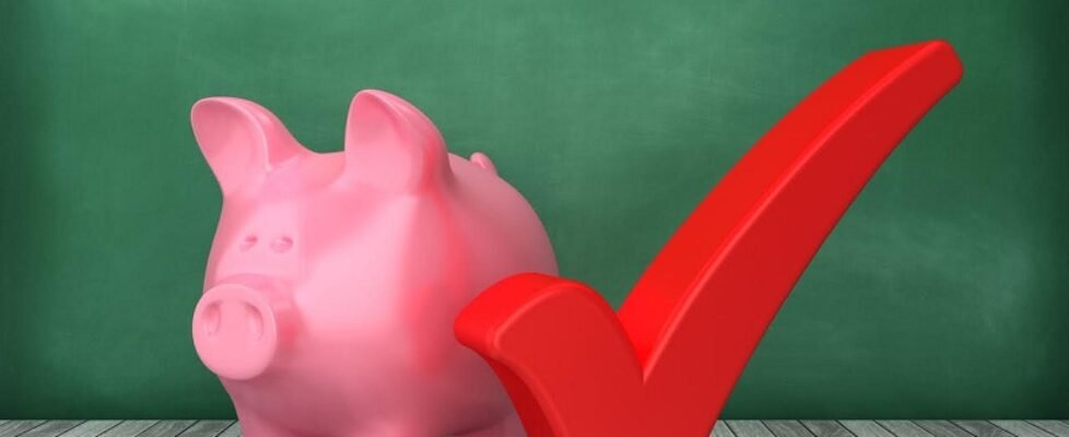 Piggy Bank with Check Mark on Chalkboard Background - 3D Rendering