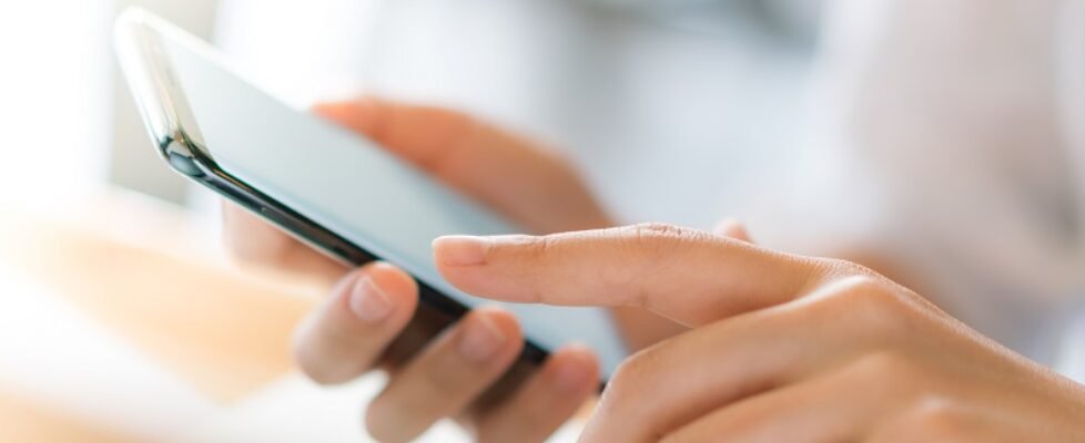 Business hand with mobile phone .