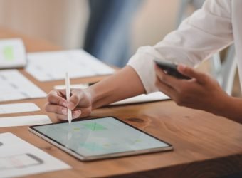 Cropped shot of youngl ux web developer working on her project while using digital tablet