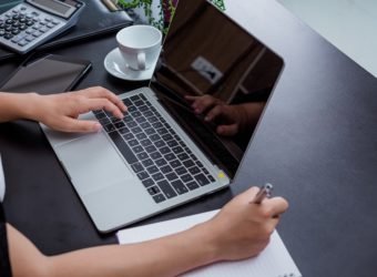 Businesswoman working in the office with a smile while sitting.