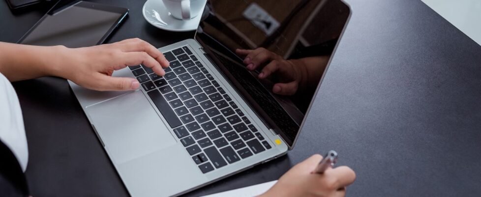Businesswoman working in the office with a smile while sitting.