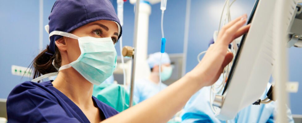 Nurse working with technology in operating room