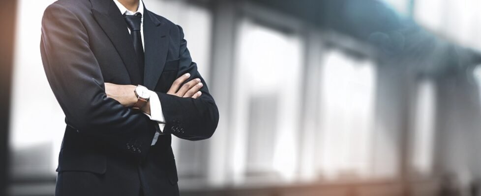 Asian Businessman on Blurred Office Background. Copy Space