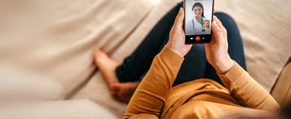 Mature woman having online consultation with doctor at home on smartphone