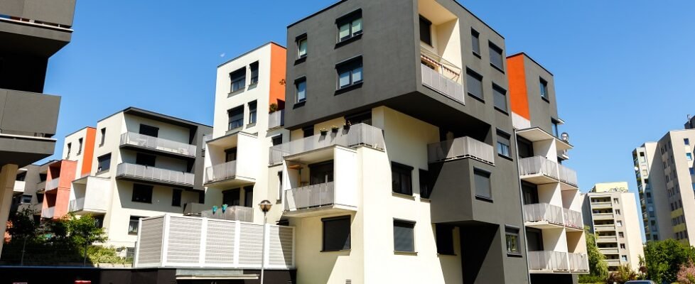 Exterior of a modern apartment buildings on a blue sky backgrou