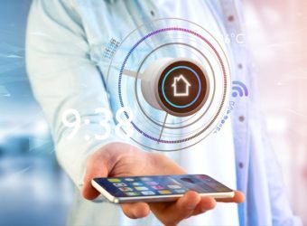 Businessman holding a Button of a smart home automation app over a smartphone- 3d rendering