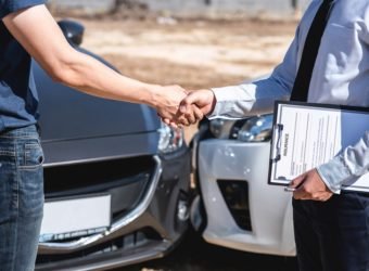 Insurance Agent and customer shaking hands after agreement about