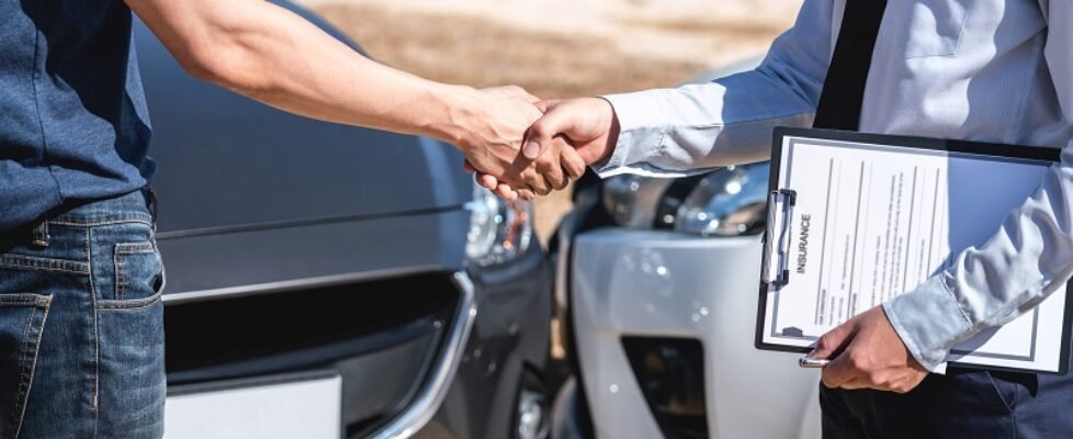 Insurance Agent and customer shaking hands after agreement about