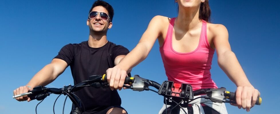 Happy young couple on a bike ride in the countryside