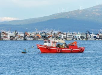 red wooden fishing boat moored in the fishing port