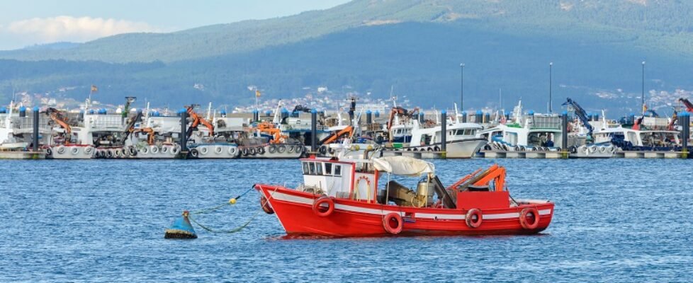 red wooden fishing boat moored in the fishing port
