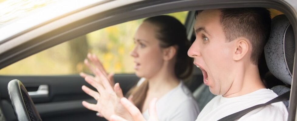 Young scared man driver and a woman passenger