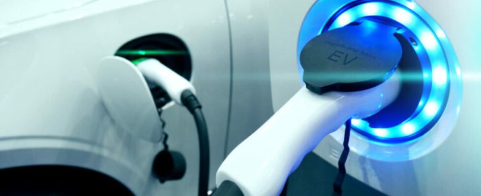 Power supply connect to electric vehicle for charge to the battery. Charging technology industry transport which are the futuristic of the Automobile. EV fuel Plug in hybrid car.