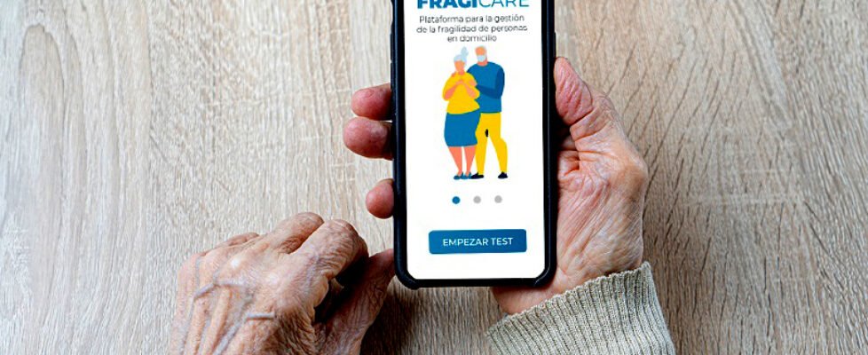 Wrinkled hands of the old woman holds a smartphone with white empty screen for your mockup