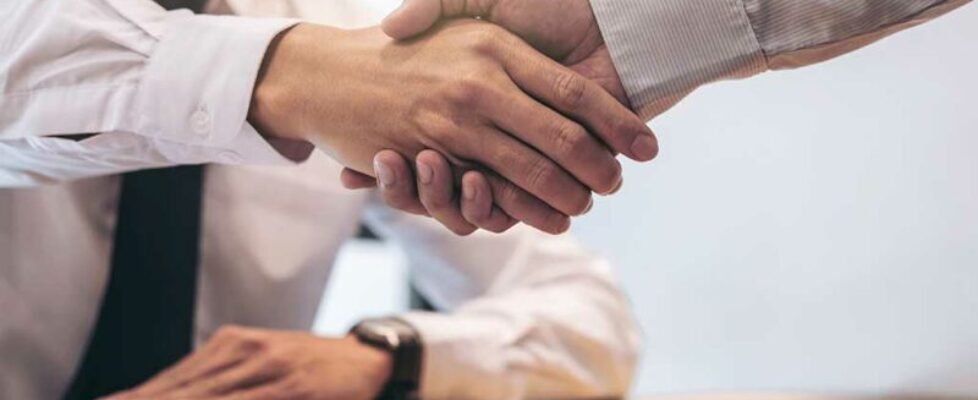 Real estate broker agent and customer shaking hands after signin
