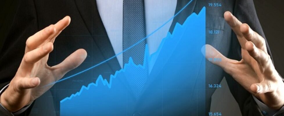 Business man holding holographic graphs and stock market statistics gain profits. Concept of growth planning and business strategy. Display of good economy form digital screen.