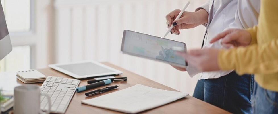 Cropped shot of youngl ux web developer working on her project while using digital tablet