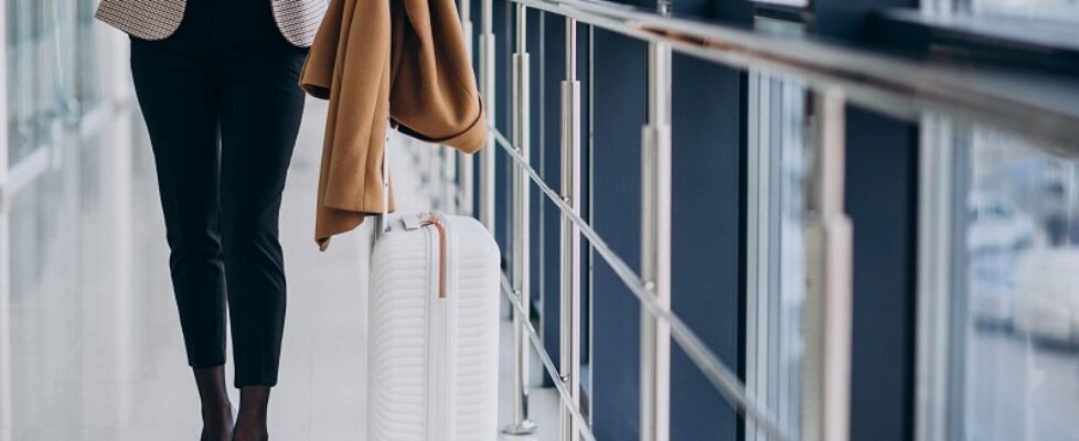 Business woman in terminal with travel bag
