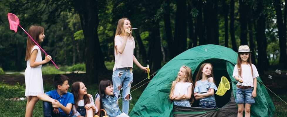 Group of teens camping in forest