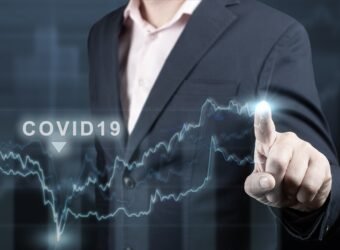 economic recovery after the fall due to the covid 19 coronavirus pandemic. Double exposure of financial graph. Businessman pointing graph corporate growth plan on dark blue