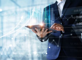 Businessman using tablet analyzing sales data and economic grow