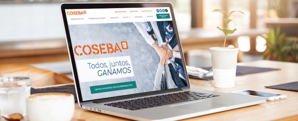 Close up minimalist shot of generic laptop computer and working accessories resting on wooden table against blurred background of cafeteria. Workplace of unknown freelancer. Selective focus