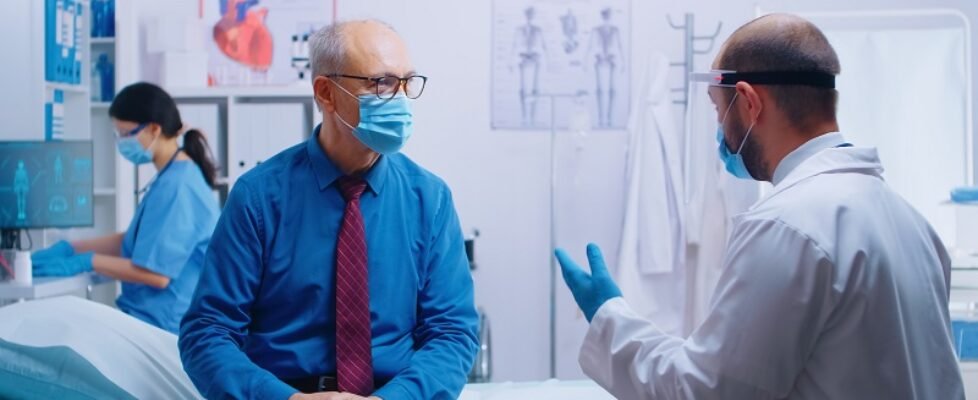 Senior man at doctor appointment during COVID-19