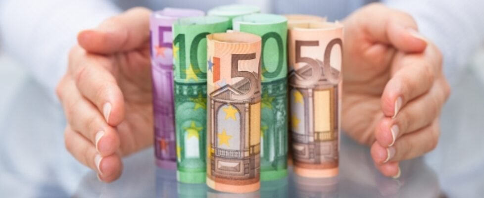 Hand Protecting Rolled Up Euro Banknote