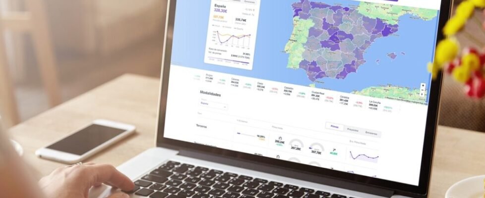 Rear view of high school girl using laptop for doing homework, browsing Internet, searching for required information, sitting at desk with mobile phone with copy space screen lying next to her