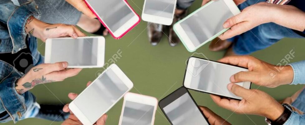 People holding mobiles and standing in circle
