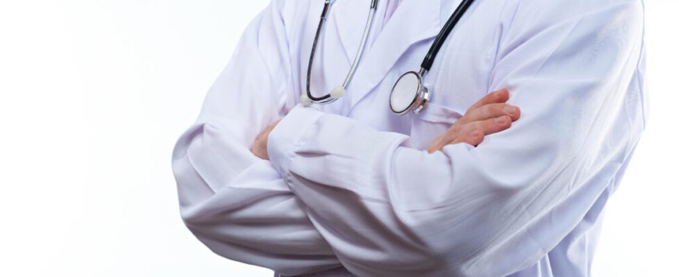 Closeup of doctor crossed arms isolated on white background