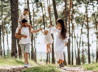 Family with baby daughter and little son in park