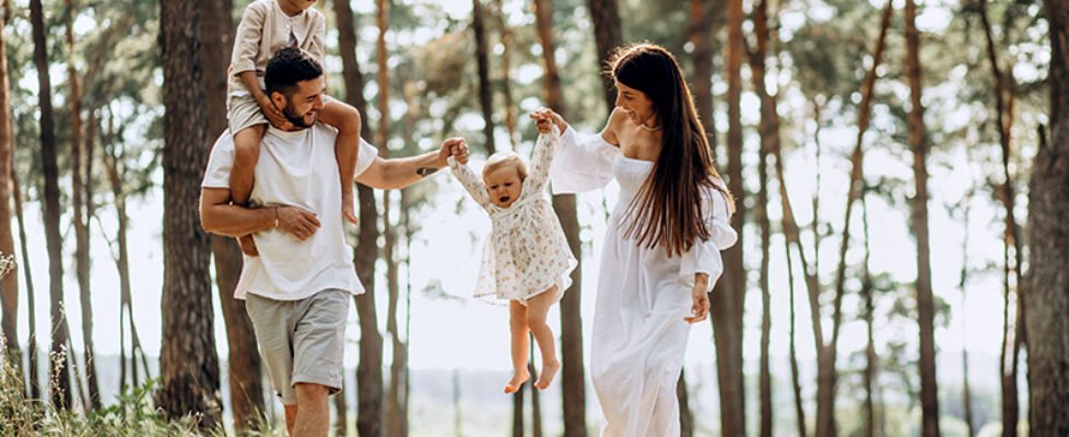 Family with baby daughter and little son in park